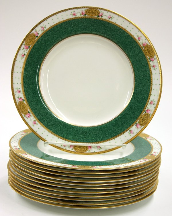 Royal Worchester dinner plates: 12 Royal Worchester gilt and polychrome decorated service plates, having a floral decorated gilt rim around a green band on a white ground 10.5''d