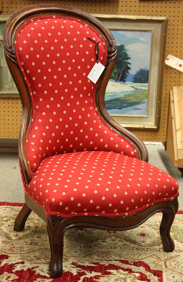 Victorian carved mahogany slipper chair: Victorian carved mahogany slipper chair circa 1870, having an arched carved crestrail and raised on cabriole legs, upholstered in burgundy fabric 37''h x 23''w