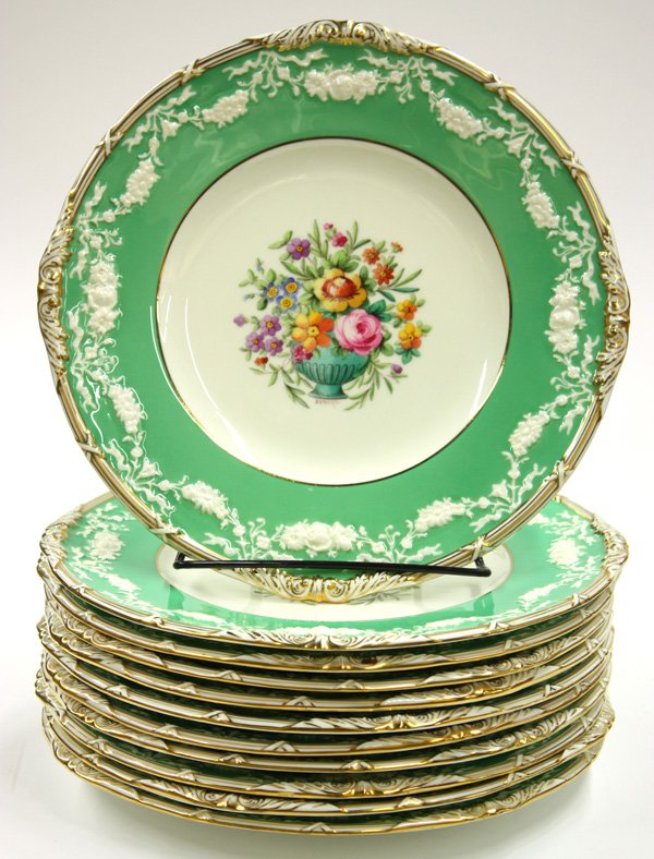 Minton dinner plates: (lot of 11) Minton gilt and polychrome decorated service plates, the gilt rim around an apple green border with floral swags around a central floral boquet signed J.H Ratcliffe 10.5''