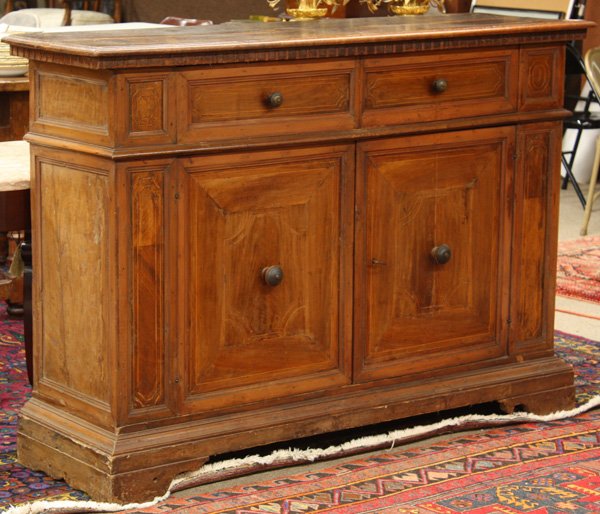 Florentine walnut credenza: Seventeenth century style Florentine walnut credenza of assembled antique elements, the rectangular top above a dentil molded apron, with string inlay, raised on bracketed feet, 42''h x 60''w x 18''d