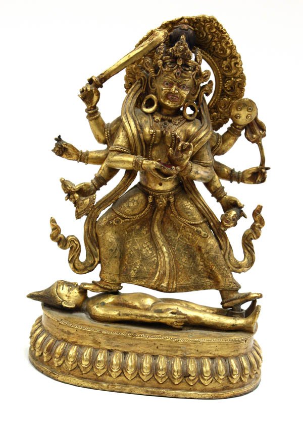 Nepalese Gilt Copper-Alloy Female Dharmapala Figu: Nepalese gilt copper-alloy figure of a dakini or female dharmapala, 19th/20th century, probably depicting an eight-arm manifestation of Sridevi standing in a brocade-patterned skirt, the skull-like vi