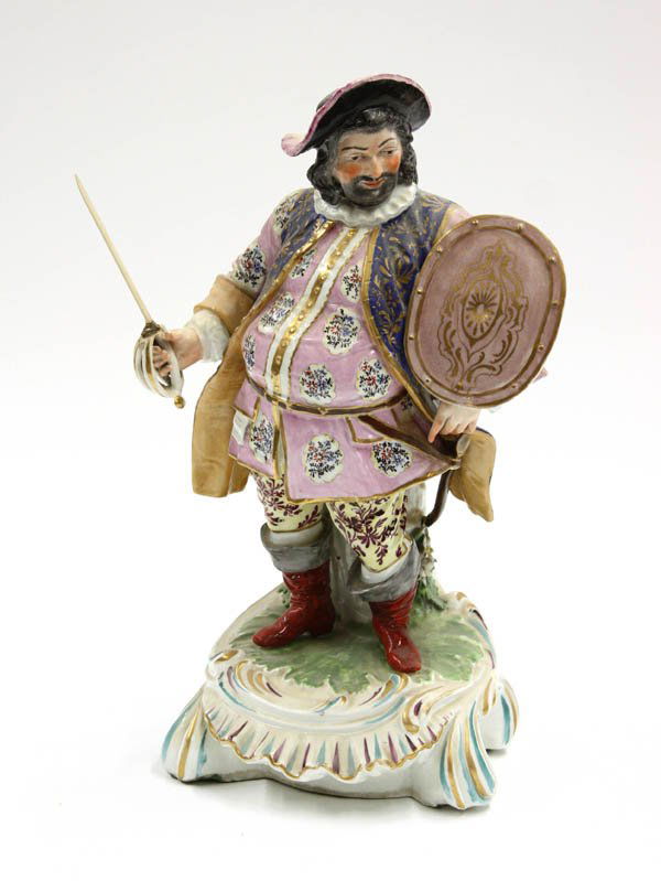 Crown Derby porcelain figure of Falstaff: Crown Derby porcelain figure of Falstaff, depicted with a rose colored shield and his duelling sword, with vividly colorful clothing accented by his crimson boots, and raised on a cartouche shaped, de