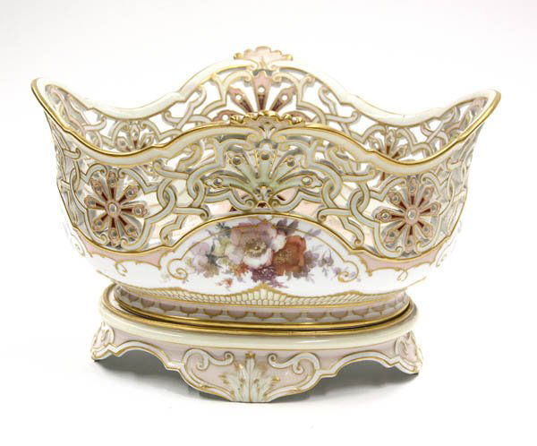 Porcelain KPM footed center bowl: Porcelain KPM footed center bowl, the reticulated border above a polychrome floral decorated body having gilt highlights and raised on a separate conforming oval decorated base with gilt embellishment