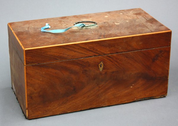 English flame mahogany tea caddy: English flame mahogany tea caddy having a lidded, fitted interior, the case with string inlay and brass handle, 6''h x 12''w x 6''d