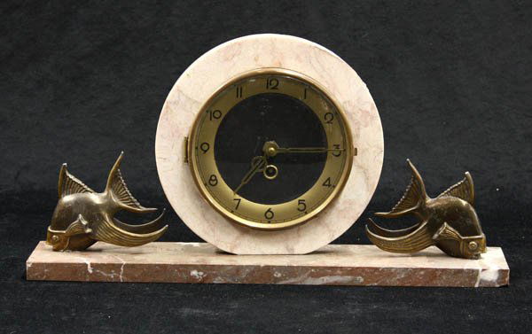 Art deco mantel clock: Art deco mantel clock having variegated marble circular clock case, with a black face having gilt brass mounts, flanked with a pair of stylized bronze fish, on a marble plinth, 9.5''h x 18''w