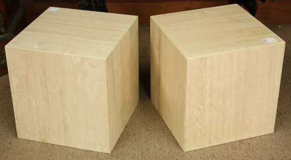 Three travertine pedestals: (lot of 3) Pair of square solid travertine low pedestals having bevelled edges 14.5''h x 14''d, together with a taller square travertine pedestal 25.5''h x 10''w