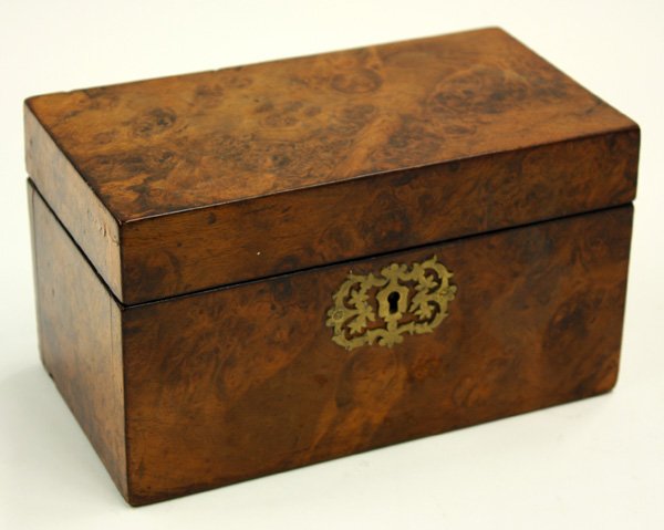 English burl walnut tea caddy: English burl walnut tea caddy, the hinged top opens to reveal two lidded tea reservoirs, the case with a reticulated escutcheon 5''h x 8.5''w x 4.5''d