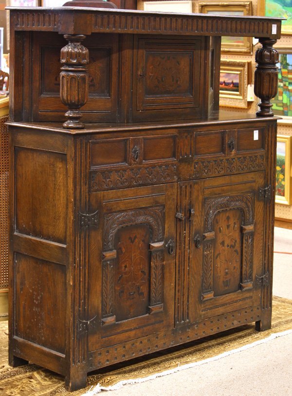 William and Mary style English oak dining suite: (lot of 15) William and Mary style English oak inlaid dining room suite, the draw leaf table with a 1.5'' top having bread board ends raised on a base with massive cup and urn carved supports raised o