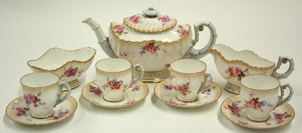 Royal Worcester porcelain tea service: (lot of 11) Royal Worcester porcelain tea service decorated with polychrome floral bouquets and gilt lined rims, comprising teapot 5.5''h, sugar with creamer 3''h, and service for 4 including cups wit