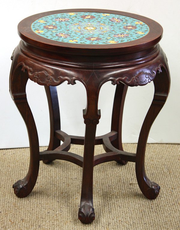 Ebonized Chinese Wood Stool/Cloisonne Plaque: Chinese ebonized wood stool, the circular top inset with three cloisonne enamel plaques featuring peony sprigs with scrolling tendrils on a turquoise ground, all set above stylized bat-form apron fram