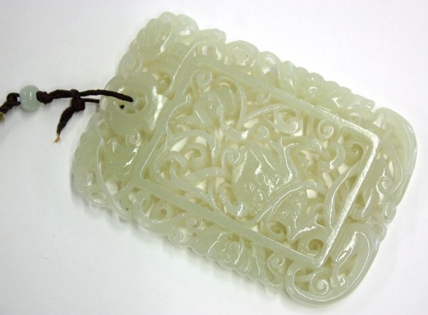 Reticulated Jade Plaque, Toad/Chanchu: Chinese pierced jade plaque, of rectangular form with a double sided openwork design featuring a three legged toad (chanchu) amid stylized scrolls, framed by further scrolling tendrils, bats, and surm