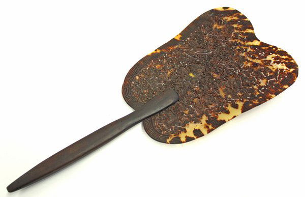 Carved Chinese Tortise Shell Fan: Chinese carved tortoise shell fan, of lobed leaf form featuring nine striding dragons on a ground pierced with dense cloud scrolls all bordered by a key-fret band, with a shaped wood handle, overall: