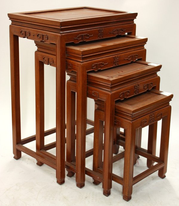 Chinese Nested Hardwood Tables: (lot of 4) Chinese set of nested hardwood tables of graduated size, each of the rectangular top set with a floating panel, above an apron carved with scrolls, shou characters (=longevity) and with a b