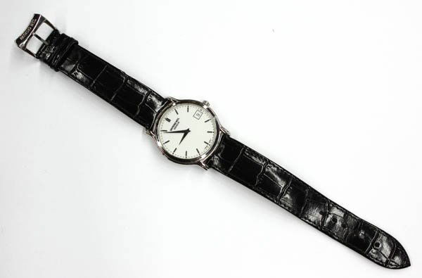 Raymond Weil stainless steel wristwatch: RAYMOND WEIL stainless steel wristwatch; with date, completed by a black strap with steel buckle. Total weight 31.9 grams.