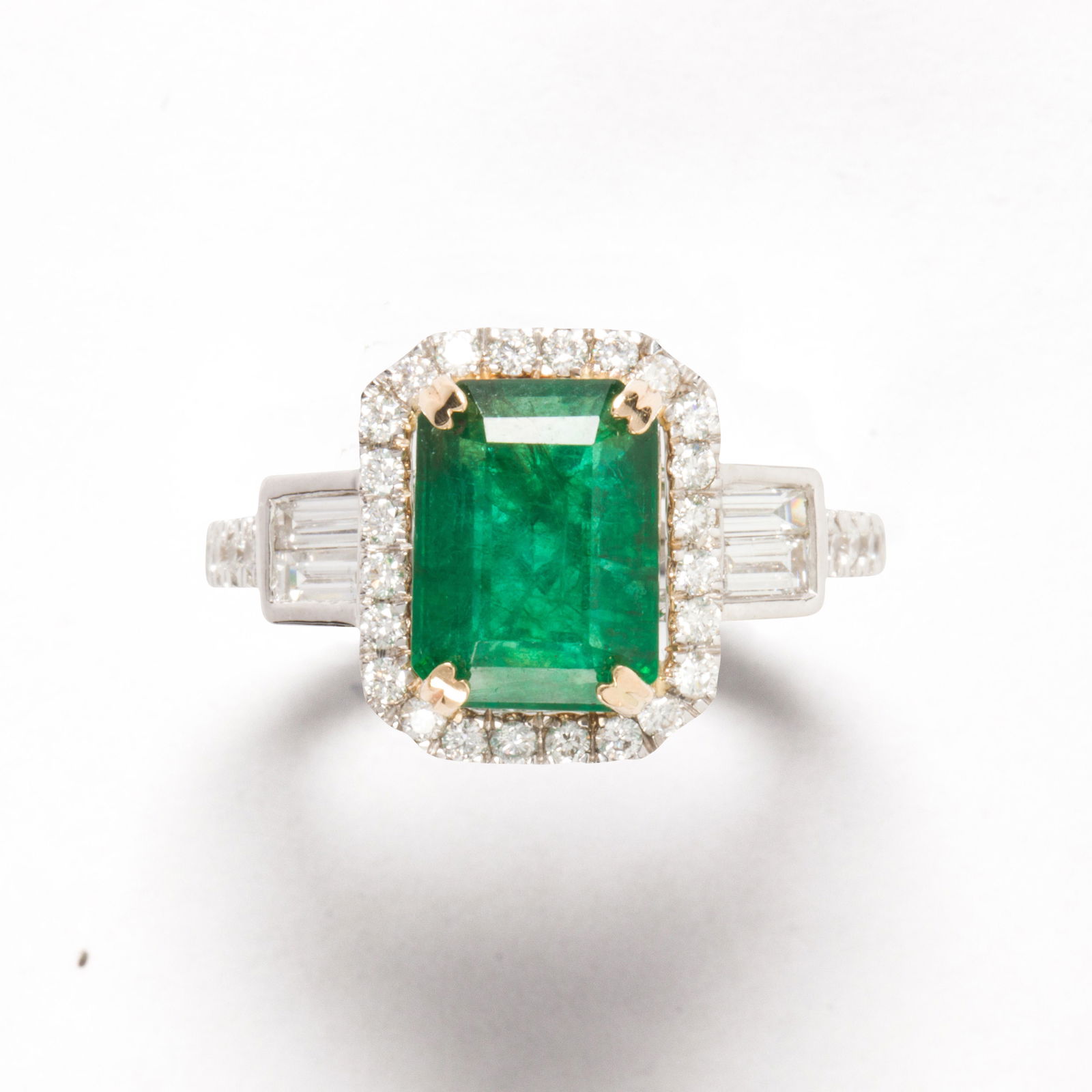 An emerald, diamond and fourteen karat white gold ring (1 of 2)