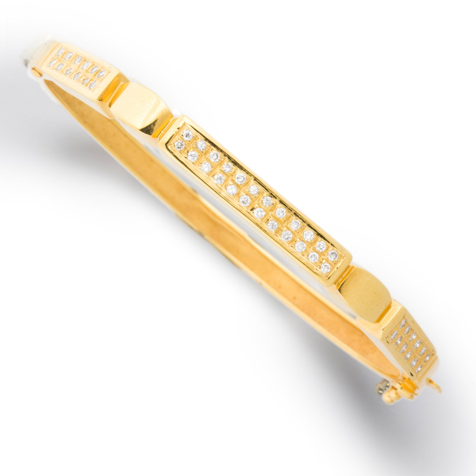 A diamond and fourteen karat gold bracelet: A diamond and fourteen karat gold bracelet of geometric design, set to the front with round brilliant-cut diamond pavÃ©. 12.1 dwt; interior circumference: 7 1/2 in