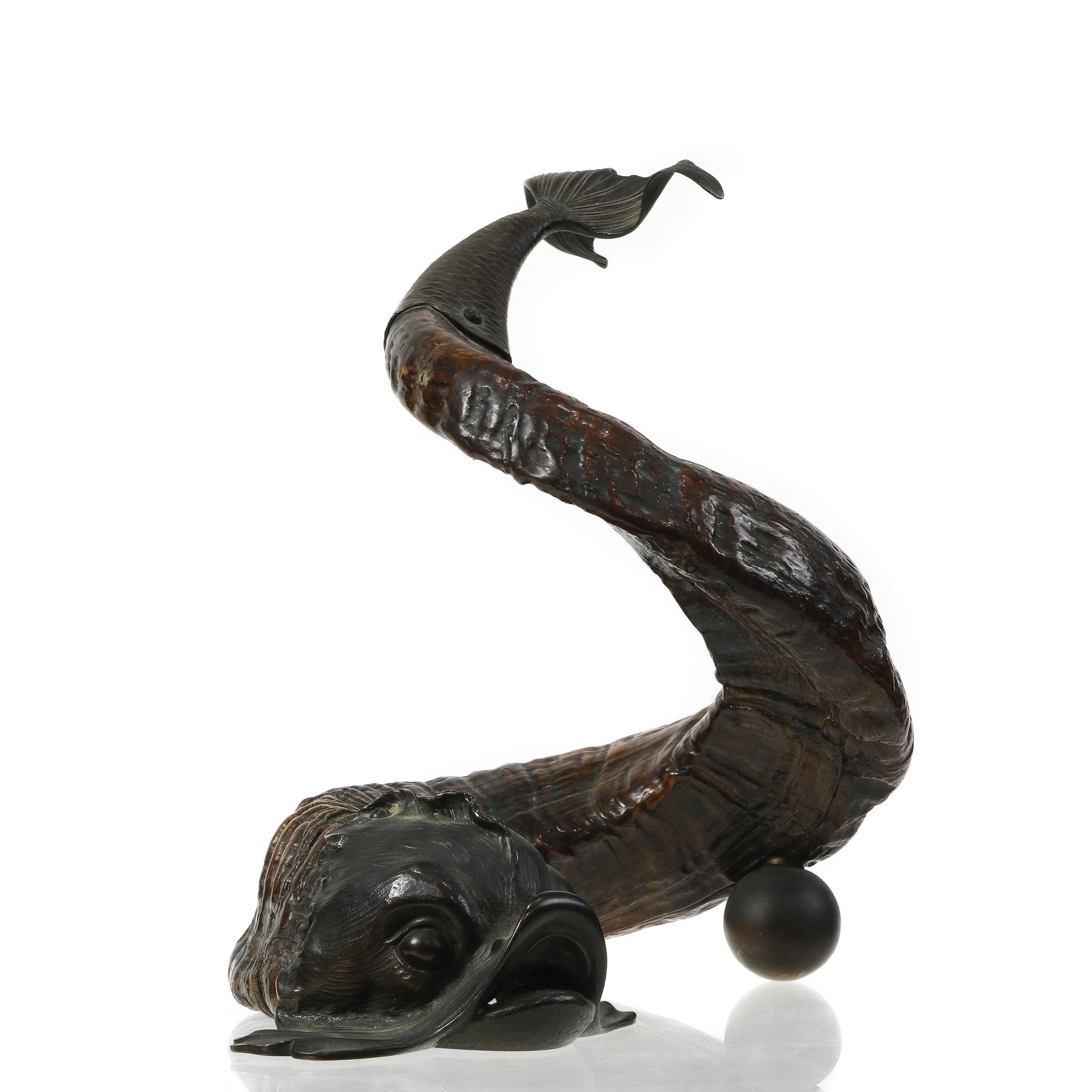 An Italian Baroque style carved wood and bronze mounted: An Italian Baroque style carved wood and bronze mounted dolphin ornament, the head and tail modeled in cast metal, the body coiled and rising on a ball support, 10 1/2"h x 11"w