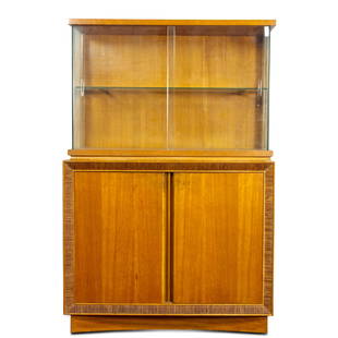 A Paul Frankl for Brown Saltman china hutch: A Paul Frankl for Brown Saltman china hutch, the superstructure having glass doors, opening to a single shelf, above the lower case having two doors accented with carved trim around edge, above a conc