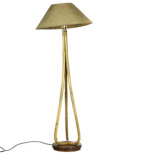 A Modernist Paul Frankl style rattan floor lamp: A Modernist Paul Frankl style rattan floor lamp, having a single light above three bamboo supports conjoined by a lower circular base, 62.5"h