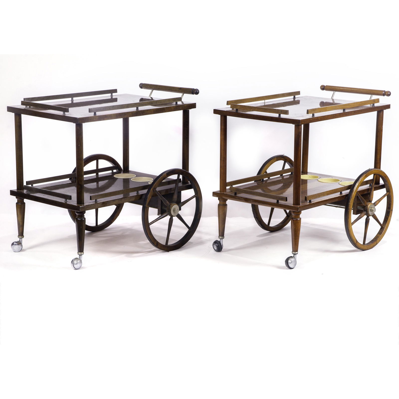 (lot of 2) Modern teak bar carts: (lot of 2) Modern teak bar carts, each lacquered rectangular top top finished with wood bars forming a gallery, over a conforming lower shelf with three apertures for bottles, a thin cylindrical rolli