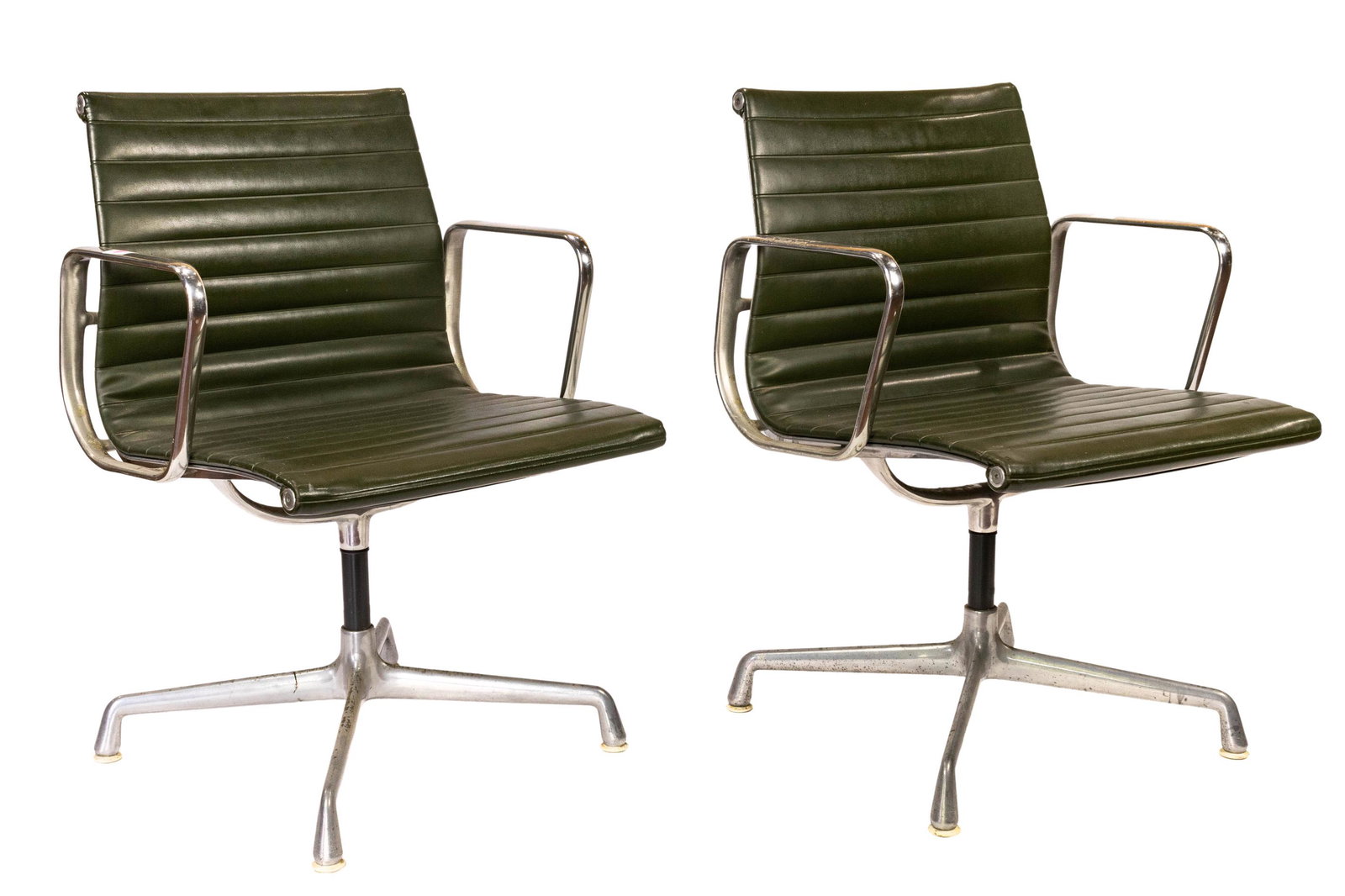 Pair of Charles and Ray Eames for Herman Miller: Pair of Charles and Ray Eames for Herman Miller, Aluminum group chairs, each having green upholstery, above an aluminum legs, 34"h