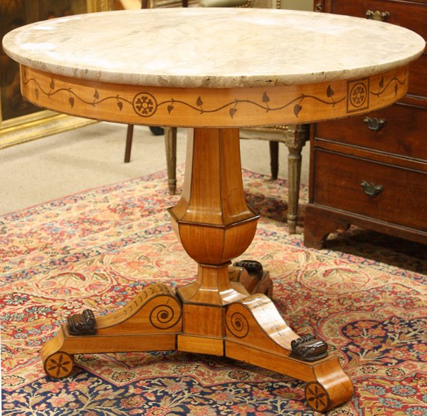 Biedermier inlaid drum table circa 1800: Biedermier inlaid drum table circa 1800, the later marble top above an apron with a leaf and vine motif raised on a tripod base, the urn shaped standard between scrolling inlaid brackets terminating a