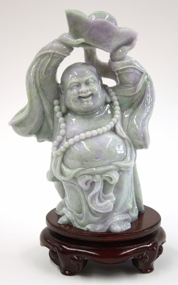 Large Chinese Jadeite Budai Figure: Chinese large jadeite figural carving of Budai, 20th century, the plump Buddhist deity wearing a loose robe and a bead necklace and standing with a large ingot held above his laughing face, the stone 