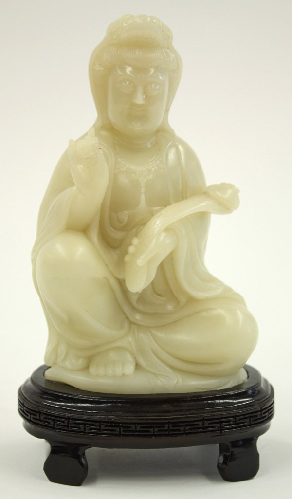 Chinese Soapstone Guanyin: Chinese soapstone figural carving of Guanyin, seated in a pose of royal ease with a ruyi scepter in one hand, the other in a gesture of reassurance, the plump face framed by a diadem partially hidden