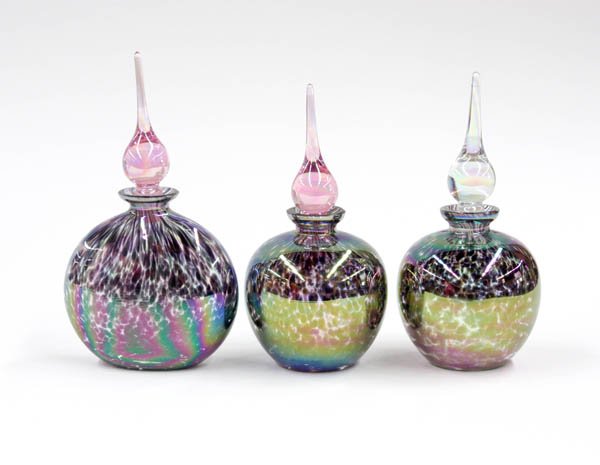 Art glass scent bottles: (lot of 3) Art glass scent bottles executed in a mottled iridescent finish with tear drop stoppers