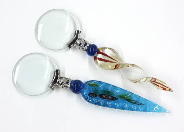 Magnifying glass: Two magnifying glasses having applied art glass handldes