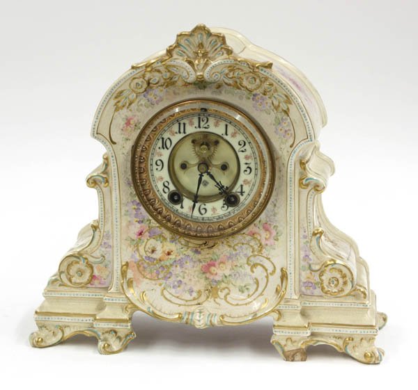 Royal Bonn porcelain mantle clock: Royal Bonn porcelain mantle clock circa 1900, the enamel and polychrome decorated case with gilt accents and marked Royal Bonn, housing an Ansonia open escapement, dial and movement having Ansonia mon