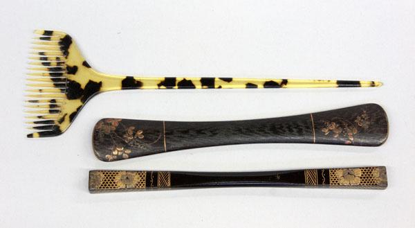 Japanese Hair Ornaments: (lot of 3) Japanese hair ornaments (kanzashi), including a tapering tortoise shell shaft terminating in a small comb, 7.25''l; and two kogai (hair sticks), each with gilt lacquer decoration, 5.875'' a