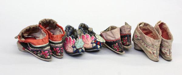 Chinese Bound Feet Lotus Slippers: Group of Chinese lotus-bud slippers for bound feet, each shaped with a point fronted by embroidered floral accents (nine pairs plus one single); together with a pair of children's shoes embroidered wi