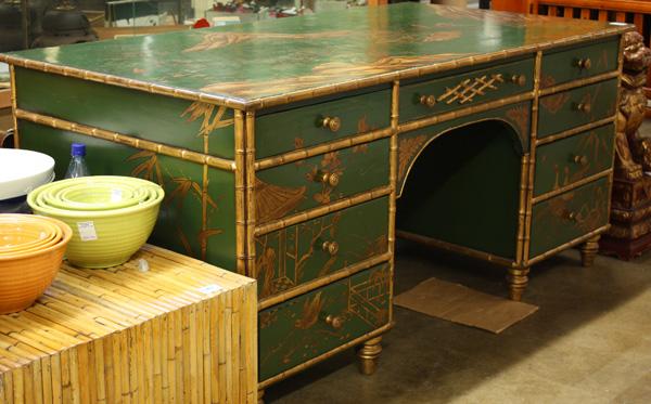 Chinoiserie Gilt/Green Painted Desk: Chinoiserie large gilt and green painted desk, 20th century, the wide rectangular top above two stacks of four drawers flanking a single central drawer, the top and sides decorated with Asian motifs i