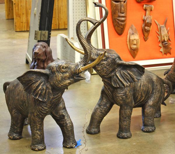Pair of bronze elephants with raised trunks: (Lot of 2) Bronze sculptures of elephants with raised trunks, lustre patina with pollished tusks, the symbolism of the raised trunk expresess good luck and fortune, 29'' x 30''