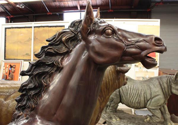 Patinated bronze sculpture of a stallion: Patinated bronze sculpture of a stallion, the life like execution showing well developed muscular features, the tail and main with a black patina and appear in motion, signed Houston on hoof, 72''h x 