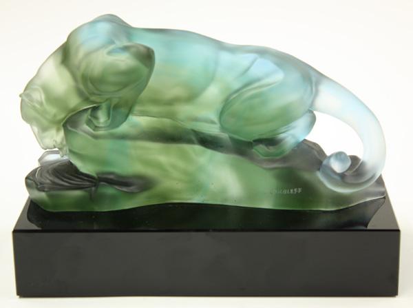 Art Glass Sculpture: Art glass sculpture in a frosted green to blue glass depicting a crouched panther on a rock drinking water mounted to a polished black marble base, inscribed I. Roubleff, 7'' x 10'' x 5''