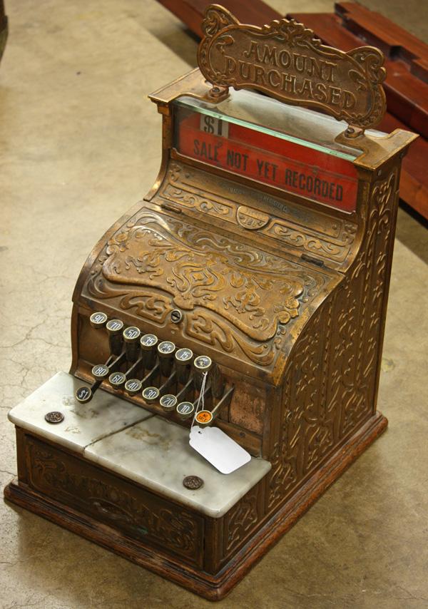 National Cash Register #130: National Cash Register #130 in an ornate Art Nouveau case having a purchase point marquee plate, a marble shelf above the money drawer, on an oak base, cracked marble, no key