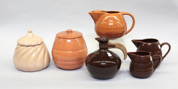 Group of Bauer of California pottery: (lot of 6) Group of Bauer of California pottery, including two cookie jars, largest 8.5''h, three ring pitchers, largest 6.25''h, and one carafe 8''h, all executed in earth tones, impressed mark