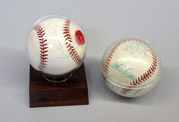 Oakland A's & SF Giants, McCovey signed baseballs: (Lot of 2) autographed baseballs in plastic ball guards, one signed by Willie McCovey, San Francisco Giants, and an Oakland A's ball signed by 32 team players