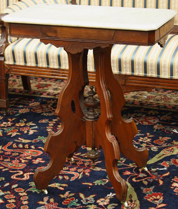 Victorian Marble Top Table: Victorian marble top table, the Carerra marble top having clipped corners and an ogee edge, above a walnut base, the four legs conjoined with a turned standard 29.5''h x 26''w x 16''d