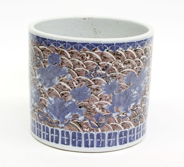 Chinese Underglaze Blue and Red Brush Pot: Chinese porcelain brush pot with underglaze blue and red decoration, featuring a group of fu-lions and its young playing with brocade balls, all on sea of red waves set within ruyi and lappet bands, 7