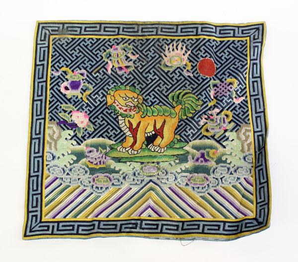 Chinese Military Rank Badge: Chinese woven military rank badge (Mandarin square), featuring a fu-lion amid a wanzi ground accented by Buddhist treasures all above a lishui border, 10.1''sq