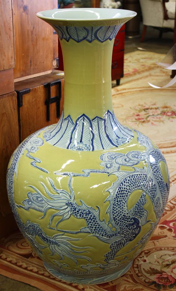 Chinese Massive Porcelain Vase, Dragon: Chinese massive polychrome enamel decorated stick neck vase, 20th century, the globular body featuring a large molded dragon picked out in cobalt blue amid a yellow glazed ground and sealed 'Jingdezhe