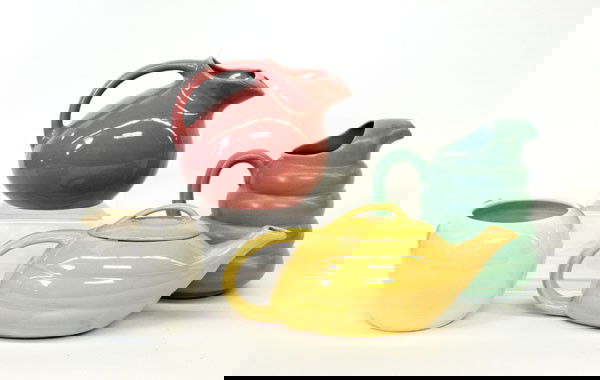 Bauer of California Pottery: (lot of 4) Bauer of California pottery, including one Fred Johnson bulbous vase 5''h, and three pitchers executed in green, pink, and yellow, largest 8''h