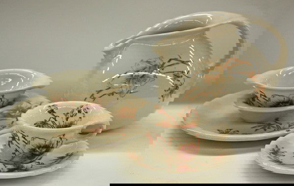 Russel Wright plates, cups,: Collection of Sterling China by Russel Wright crafted in a beige ground with transfer decorated flowers, consisting of plates, cups, saucers, berry bowls, and pitcher, 74 pieces total