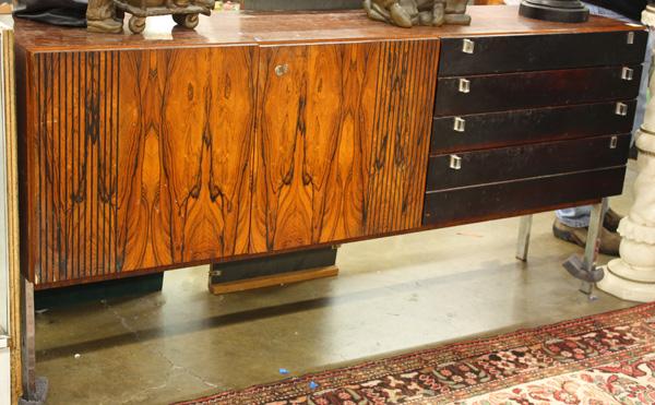 Danish rosewood credenza in the style of Kajaer: Danish credenza, circa 1960, in the style of Bodil Kjaer, Brazilian rosewood case, credenza doors having highly figured bookmatched rosewood, five ebonized maple drawers, having acrylic pulls, rising