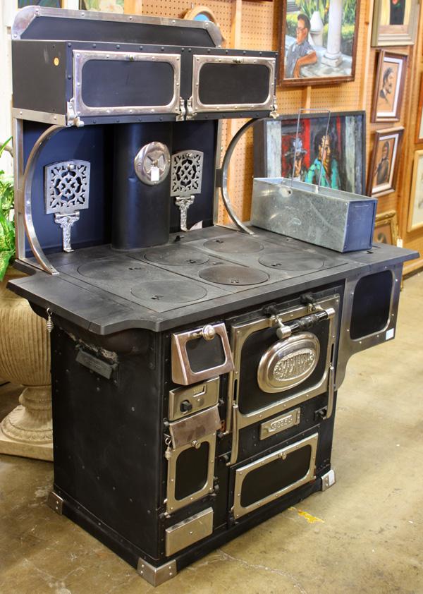 Zenith Cast Iron Stove: Zenith cast iron stove, having chrome accents, the top with six covered burners above the stove, having a central door with a Zenith medallion, and, number 3525A, 62.5''h x 52''w x 28''d