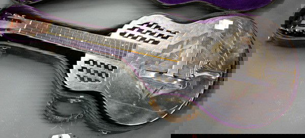 National steel resonator guitar: National steel resonator guitar, also known as a resophonic acoustic or steel lap guitar, includes original hard case 38.5'' x 14.25''