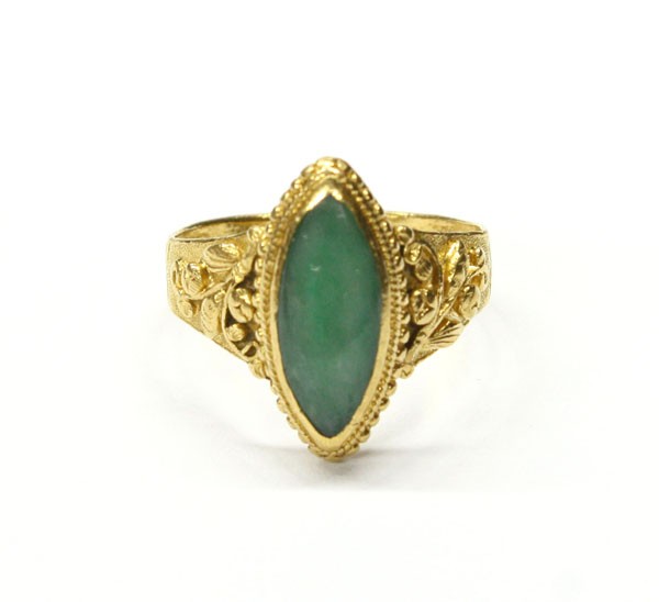 Jade cabochon yellow gold Chinese ring: Jade cabochon Chinese ring; mounted in 24k yellow gold, with floral shoulder details and granular framed navette jade cabochon crown. Total ring weight 5.3 grams. Ring size 5.75.
